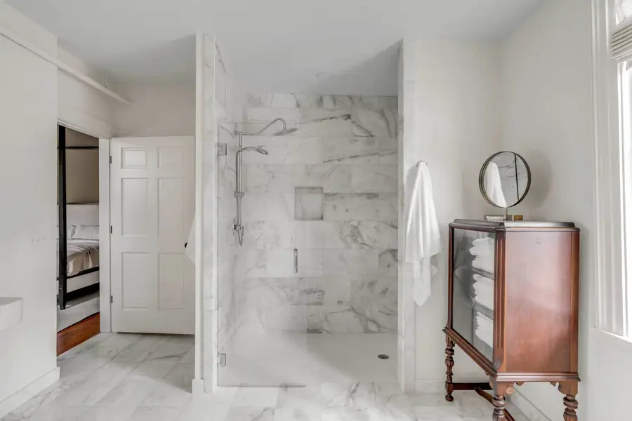 Bathroom #1: Indulge in a spa-like retreat featuring a soaking tub, walk-in shower, dual vanities, plush bathrobes, and elegant luxury finishes.