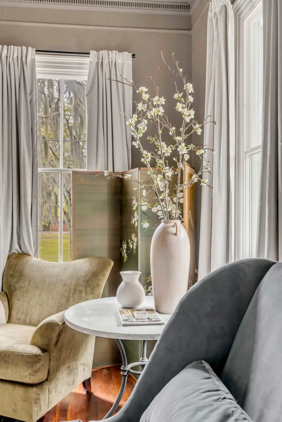 Bedroom #1: Bright, elegant, and inviting, this king suite offers a plush bed, cozy sofa, TV, and plenty of natural light for a truly relaxing stay.
