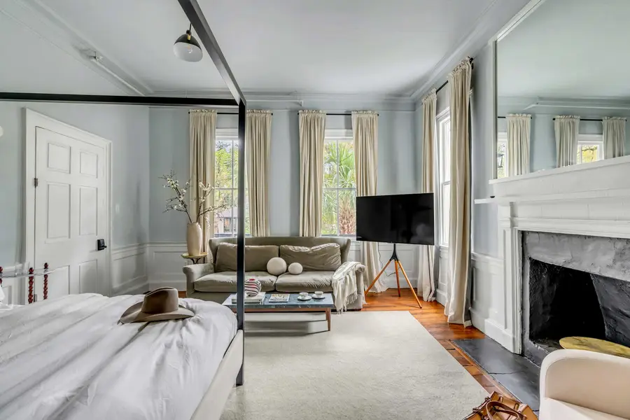 Bedroom #1: Bright, elegant, and inviting, this king suite offers a plush bed, cozy sofa, TV, and plenty of natural light for a truly relaxing stay.