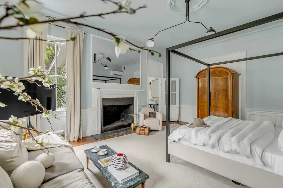 Bedroom #1: Bright, elegant, and inviting, this king suite offers a plush bed, cozy sofa, TV, and plenty of natural light for a truly relaxing stay.