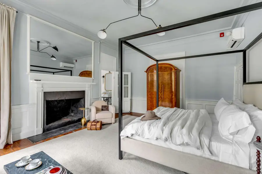 Bedroom #1: Bright, elegant, and inviting, this king suite offers a plush bed, cozy sofa, TV, and plenty of natural light for a truly relaxing stay.