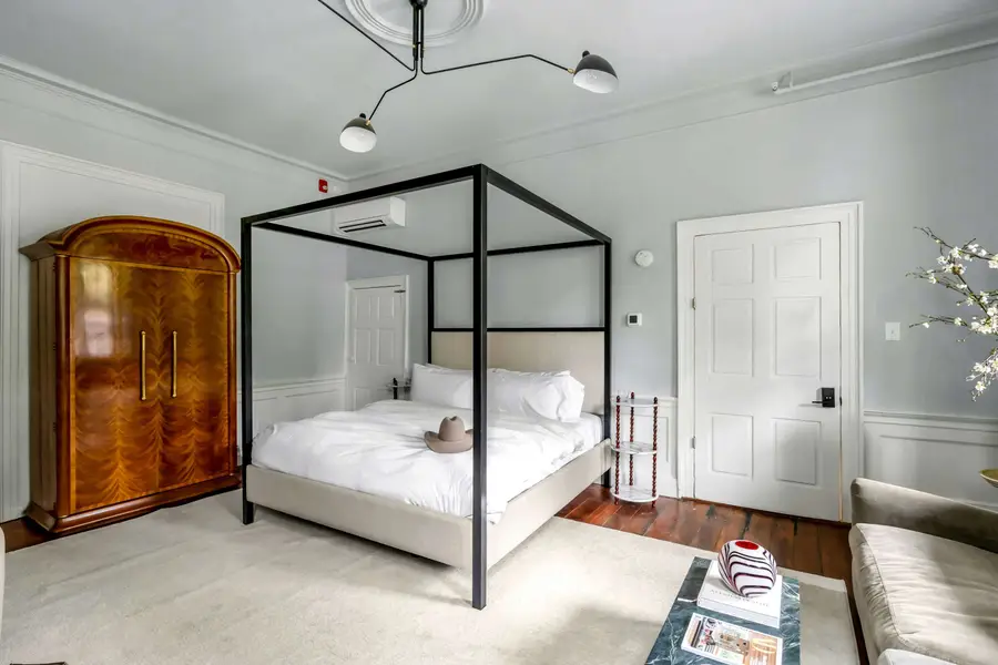 Bedroom #1: Bright, elegant, and inviting, this king suite offers a plush bed, cozy sofa, TV, and plenty of natural light for a truly relaxing stay.
