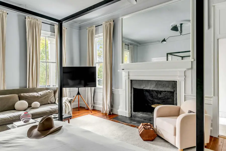 Bedroom #1: Bright, elegant, and inviting, this king suite offers a plush bed, cozy sofa, TV, and plenty of natural light for a truly relaxing stay.