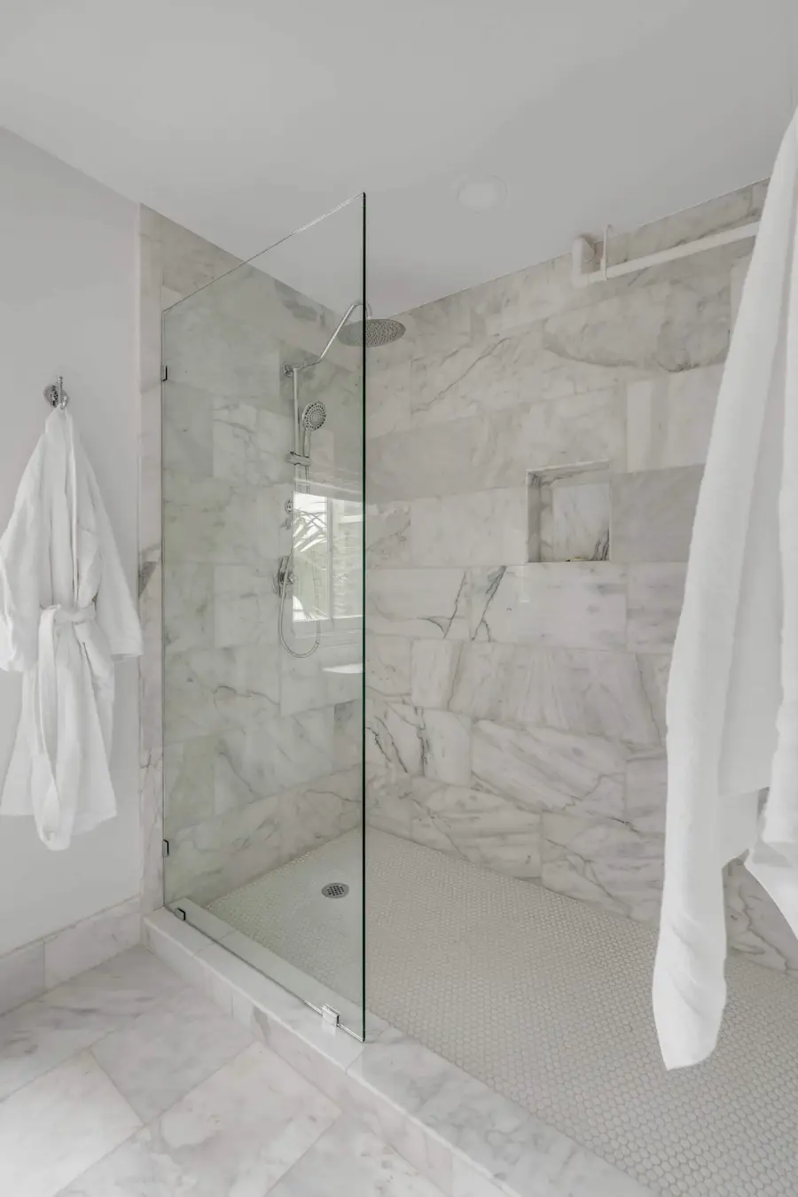Bathroom #1: Refresh in a beautifully designed bathroom featuring a spacious walk-in shower and elegant finishes.