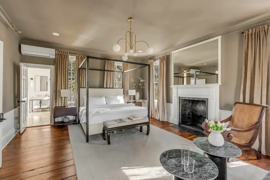 Bedroom #1: Bright, elegant, and inviting, this king suite offers a plush bed, cozy sofa, TV, and plenty of natural light for a truly relaxing stay.
