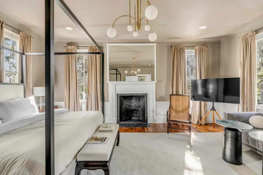 Bedroom #1: Bright, elegant, and inviting, this king suite offers a plush bed, cozy sofa, TV, and plenty of natural light for a truly relaxing stay.