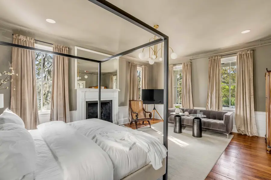 Bedroom #1: Bright, elegant, and inviting, this king suite offers a plush bed, cozy sofa, TV, and plenty of natural light for a truly relaxing stay.