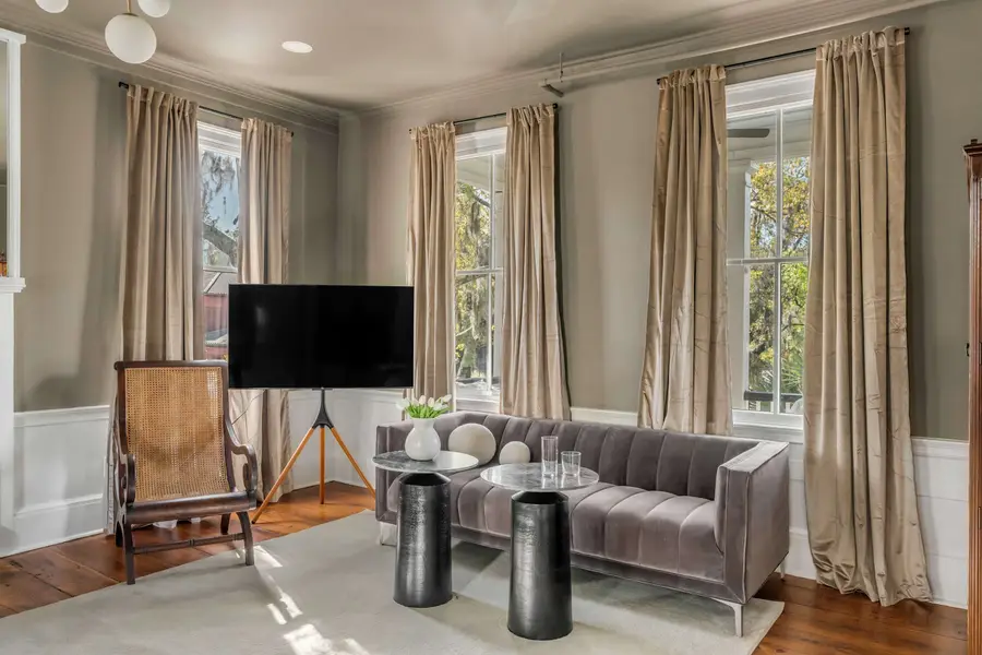 Bedroom #1: Bright, elegant, and inviting, this king suite offers a plush bed, cozy sofa, TV, and plenty of natural light for a truly relaxing stay.