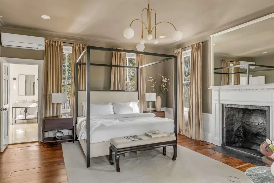 Bedroom #1: Bright, elegant, and inviting, this king suite offers a plush bed, cozy sofa, TV, and plenty of natural light for a truly relaxing stay.