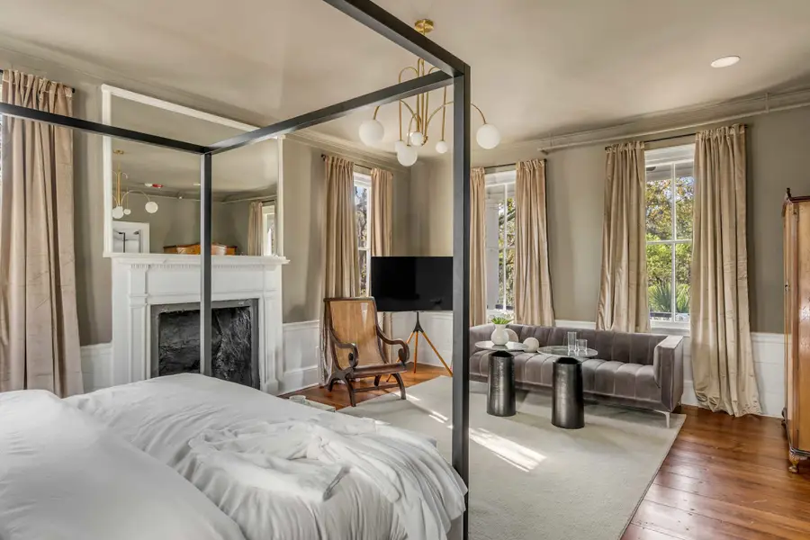 Bedroom #1: Bright, elegant, and inviting, this king suite offers a plush bed, cozy sofa, TV, and plenty of natural light for a truly relaxing stay.