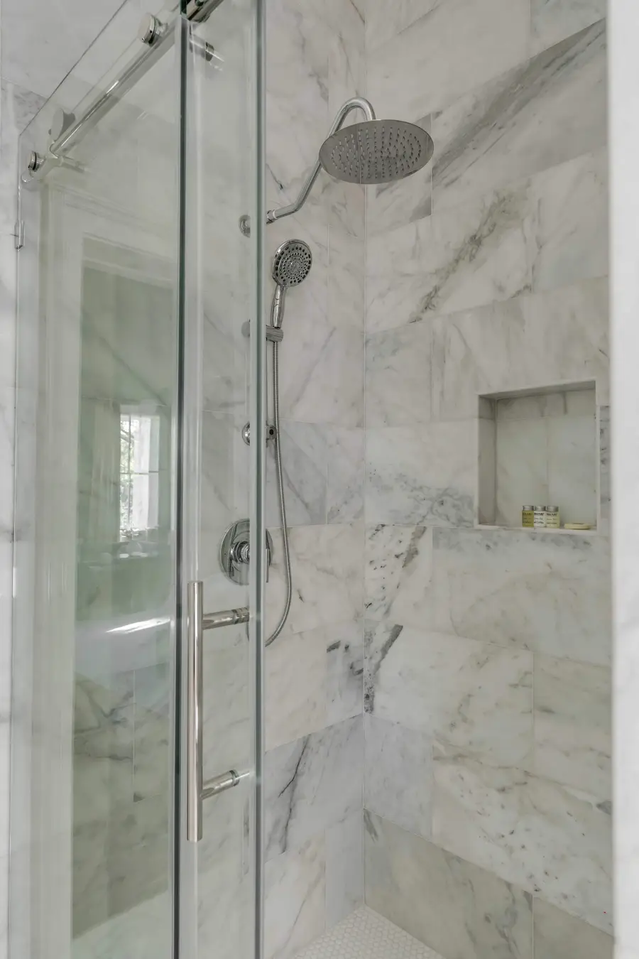 Bathroom #1: Indulge in a spa-like retreat featuring a walk-in shower, plush bathrobes, and elegant luxury finishes.