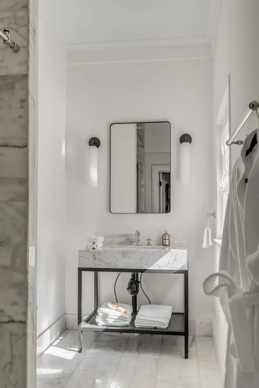 Bathroom #1: Indulge in a spa-like retreat featuring a walk-in shower, plush bathrobes, and elegant luxury finishes.