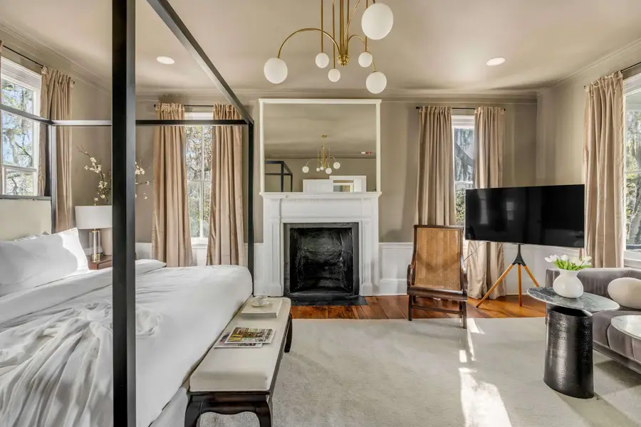 Bedroom #1: Bright, elegant, and inviting, this king suite offers a plush bed, cozy sofa, TV, and plenty of natural light for a truly relaxing stay.
