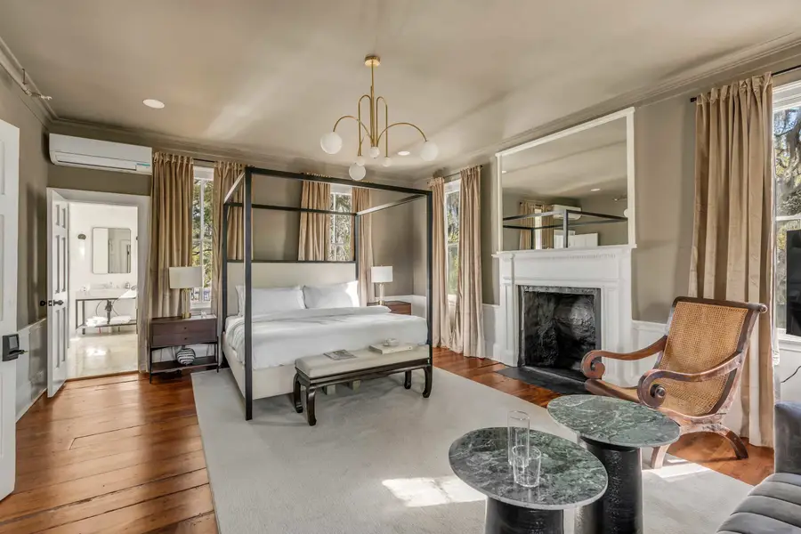 Bedroom #1: Bright, elegant, and inviting, this king suite offers a plush bed, cozy sofa, TV, and plenty of natural light for a truly relaxing stay.