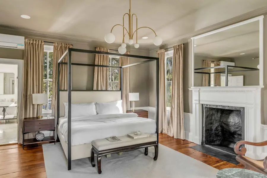 Bedroom #1: Bright, elegant, and inviting, this king suite offers a plush bed, cozy sofa, TV, and plenty of natural light for a truly relaxing stay.