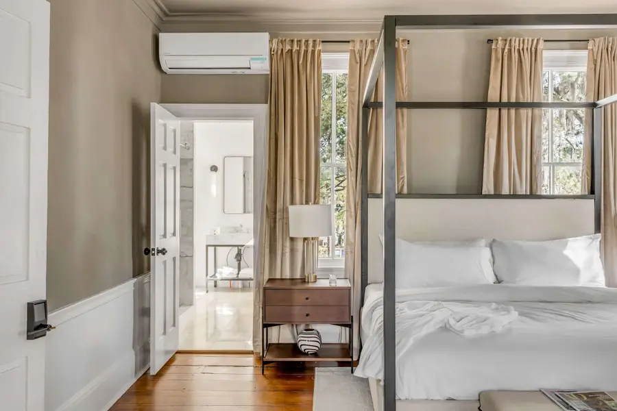 Bedroom #1: Bright, elegant, and inviting, this king suite offers a plush bed, cozy sofa, TV, and plenty of natural light for a truly relaxing stay.