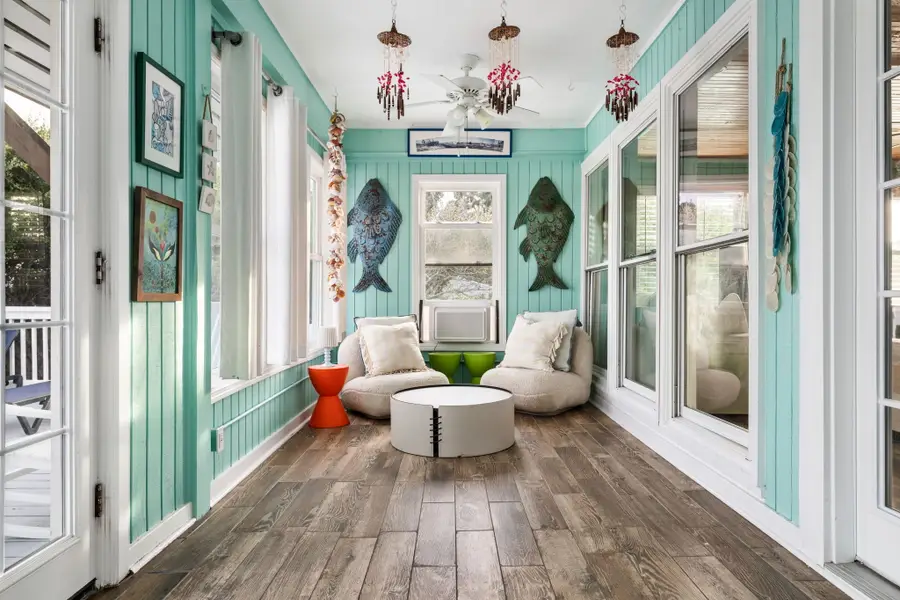 A cozy coastal nook with plush seating and sun-filled windows, perfect for slowing down and soaking in the beach vibe.