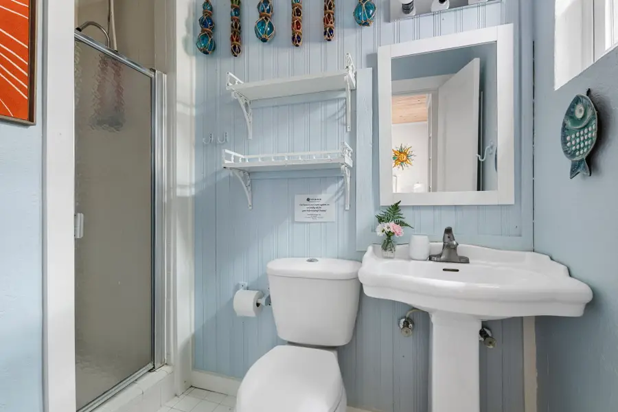 Bathroom #1: Offers a walk in shower and everything you need to refresh after a day at the beach.