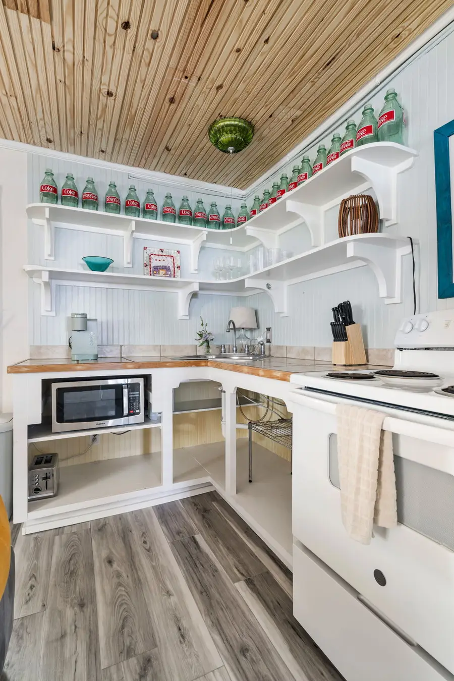 Cook with ease in the fully equipped kitchen featuring a full size refrigerator, stove, oven, microwave, dishwasher, coffee maker, toaster, blender, and all the cooking essentials.