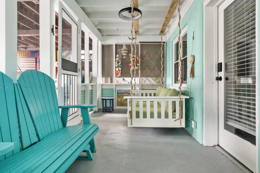 Spacious porch with plenty of comfortable seating, offering another inviting spot to relax.
