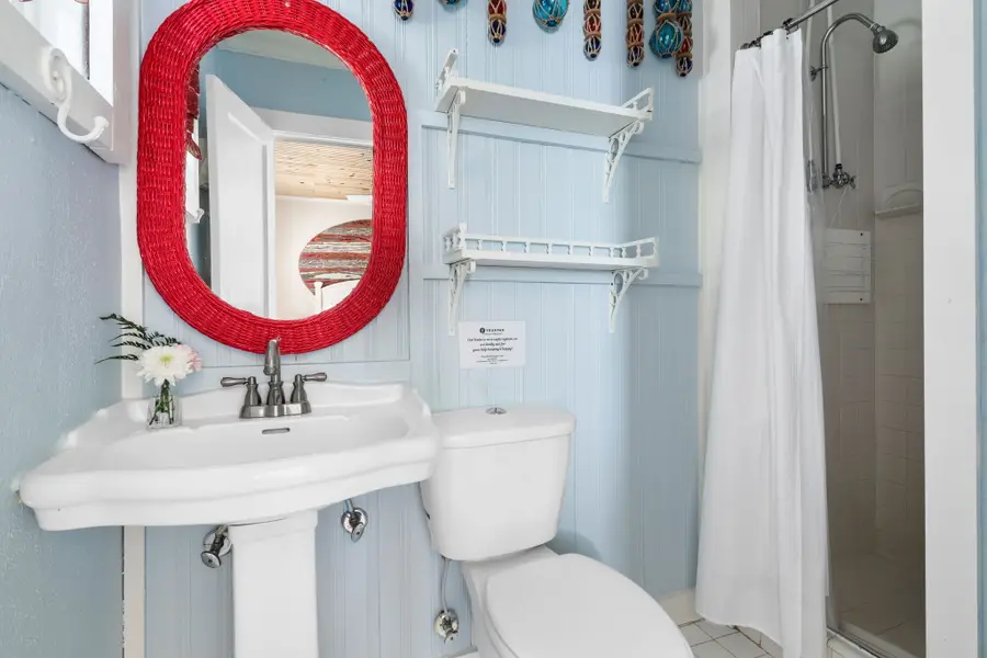 Bathroom #2: Offers a spacious walk in shower, perfect for freshening up after a day at the beach.