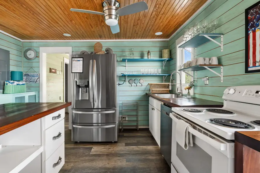 Cook with ease in the fully equipped kitchen featuring a full size refrigerator, stove, oven, microwave, dishwasher, coffee maker, toaster, blender, and all the cooking essentials.
