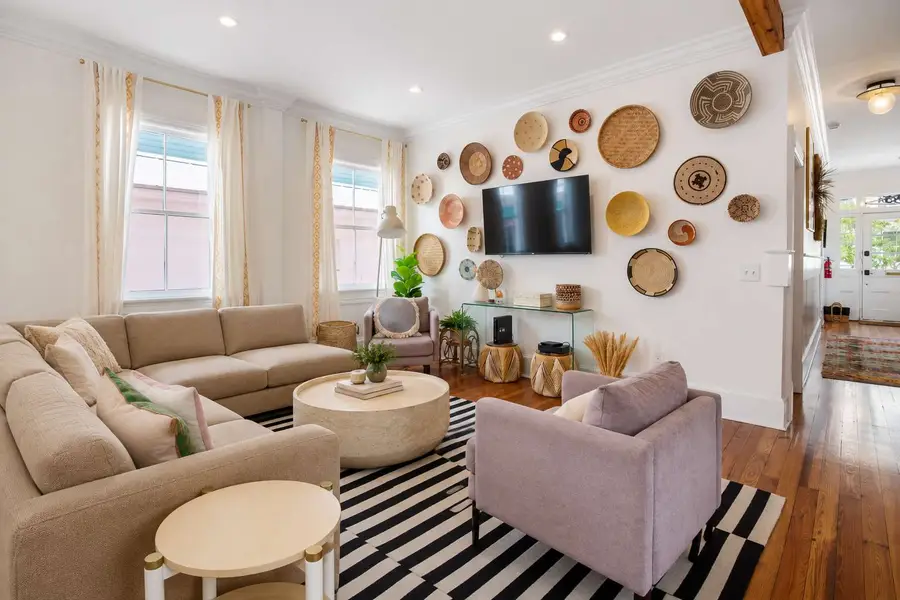 Spacious, pristine living room with cable TV and a smart TV