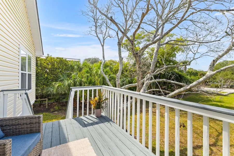 Back porch with seating, there is a massive backyard for yard games. Looking forward to hosting your group soon! 