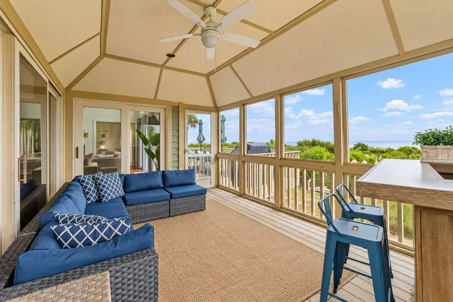 Screened in porch with a bar and beach views 