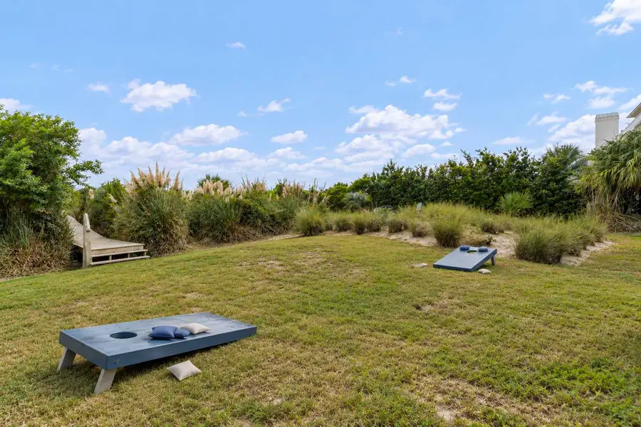 Backyard space with corn hole set 