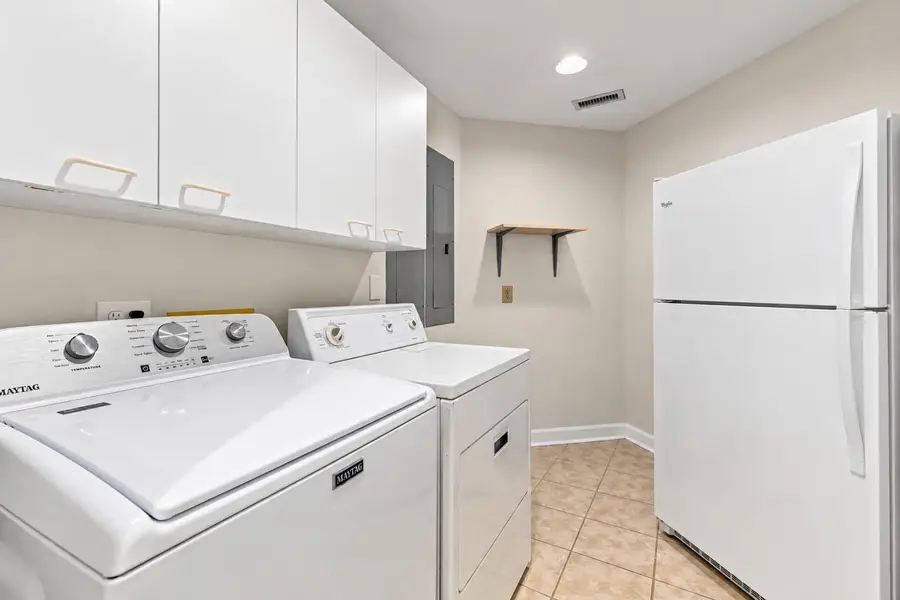 Laundry room with an extra refrigerator  
