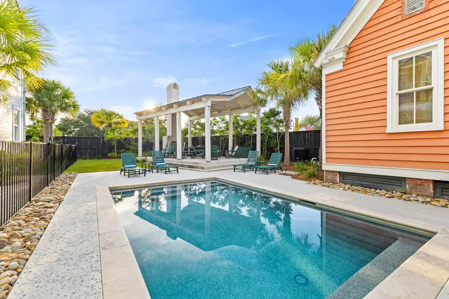 Soak up the sunshine by the sparkling shared pool or relax on the lounge chairs in this inviting outdoor retreat.