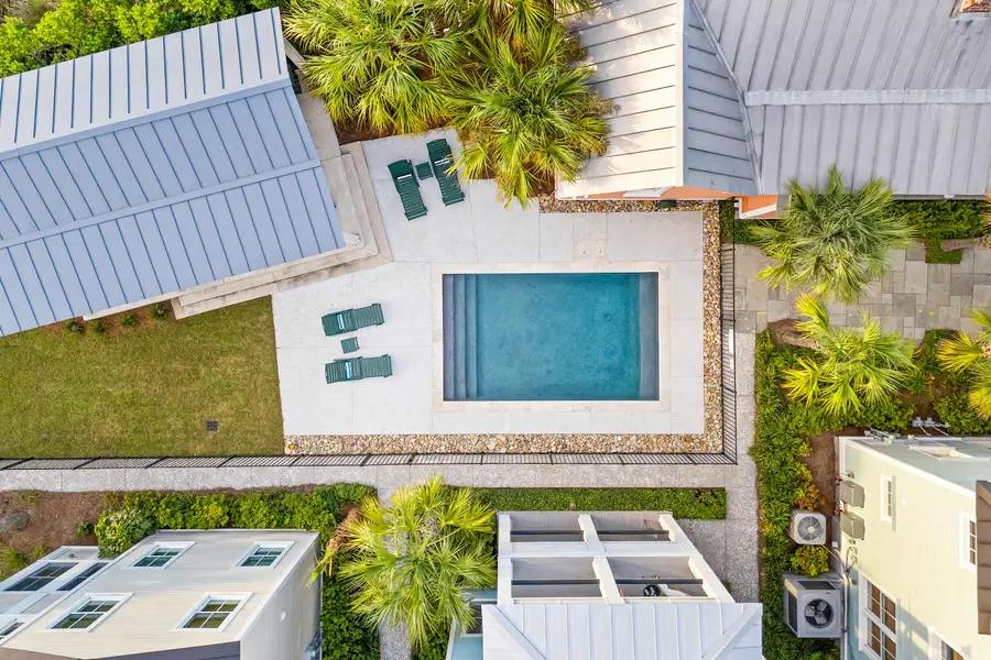 Top view of the shared outdoor retreat with sparkling pool and lounge chairs.