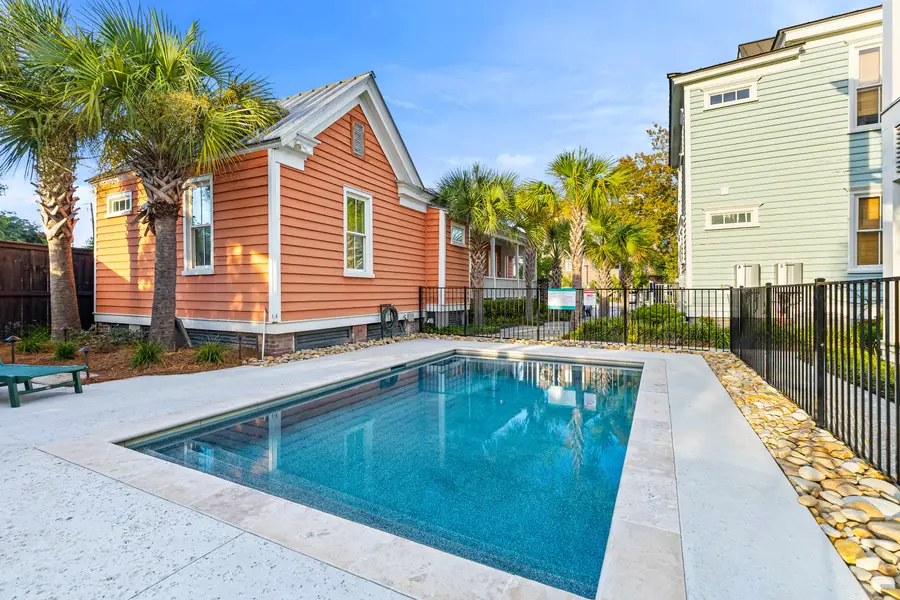 Soak up the sunshine by the sparkling shared pool or relax on the lounge chairs in this inviting outdoor retreat.