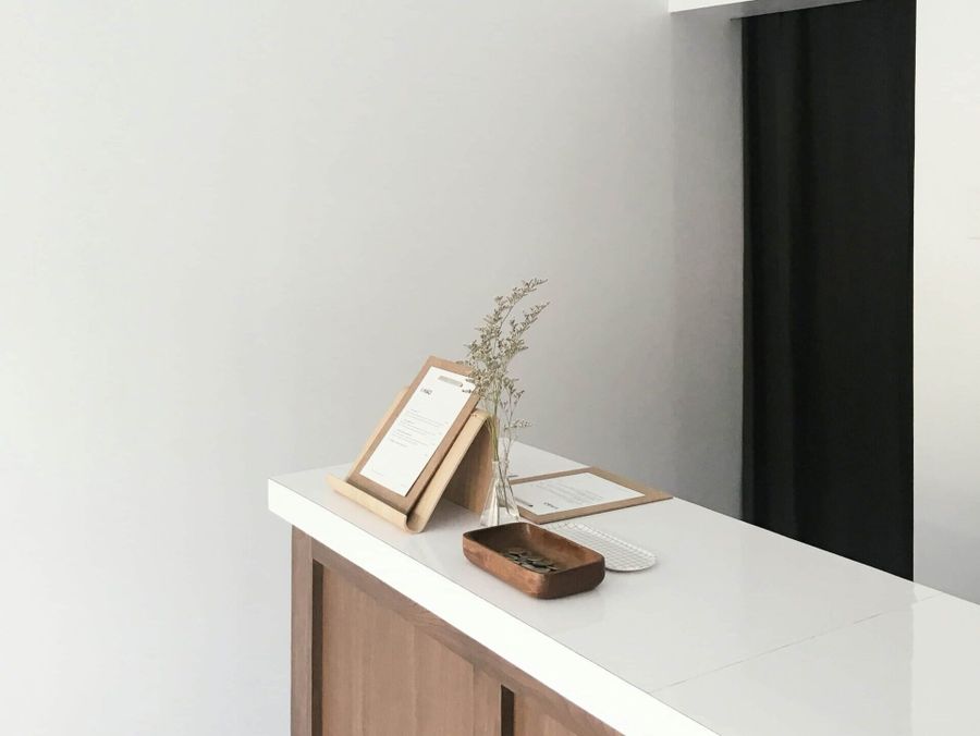 a white counter with a light from the ceiling