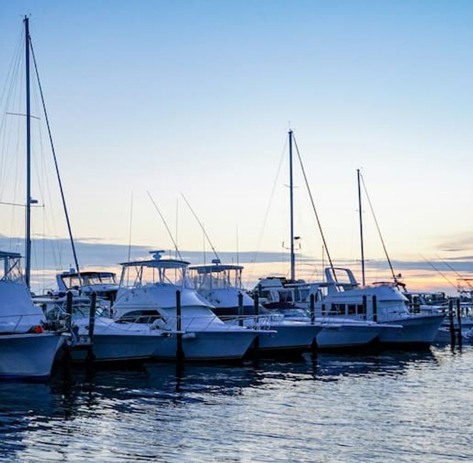 Yachts at a dock at sunset